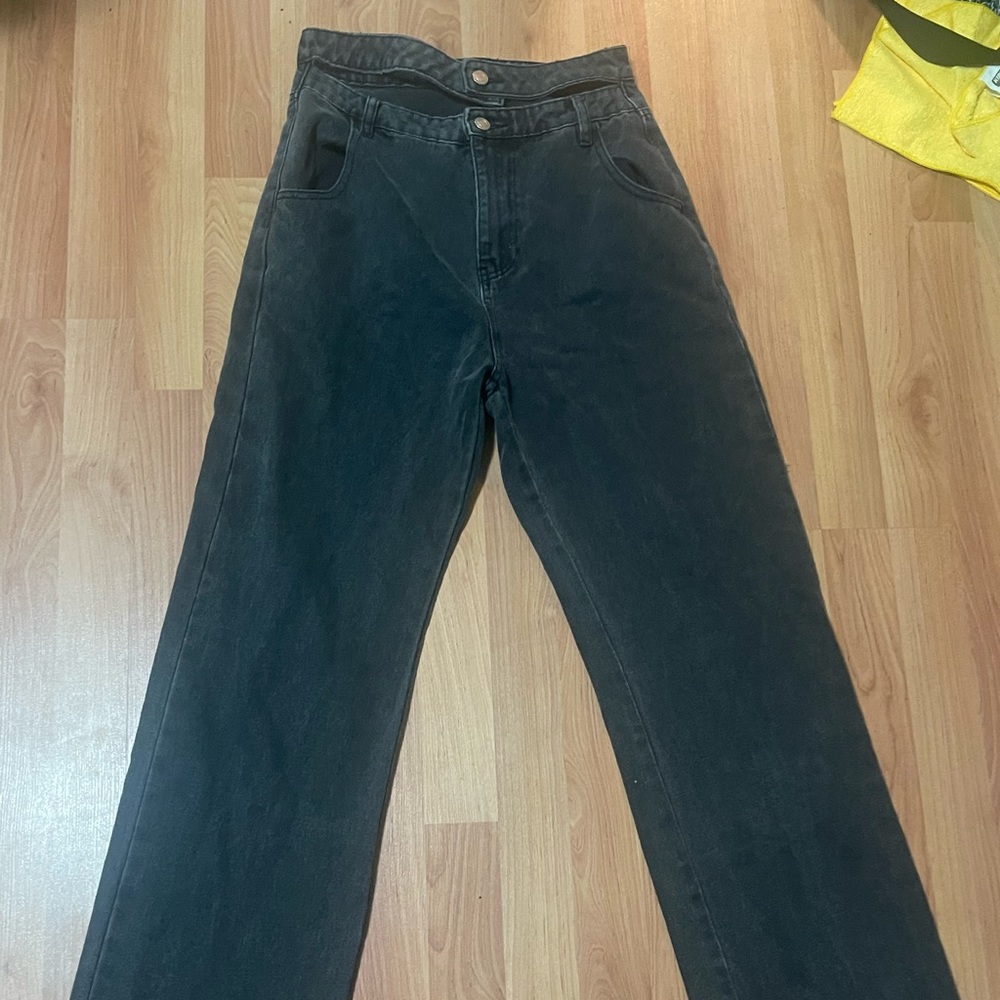 asymmetric black jeans with two buttons